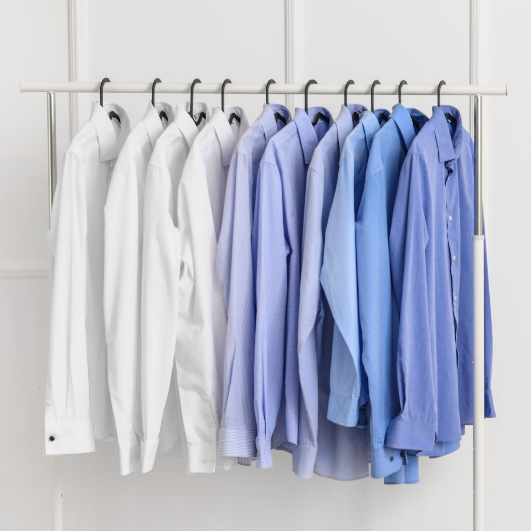 Clean dress shirts hanging on a rack