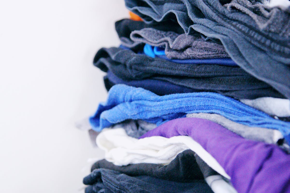 A stack of neatly folded clothes ready for a commercial laundry account